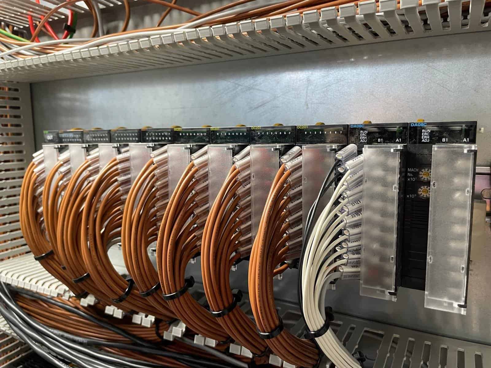 PLC output modules and terminated wiring inside an industrial control panel